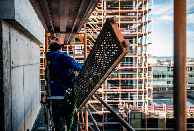Construction worker on a high rise with fall protection equipment