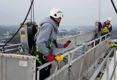 Two workers on a suspended platform